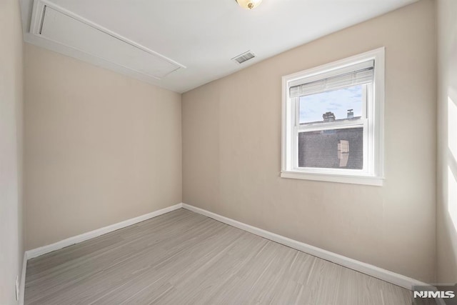 spare room featuring light hardwood / wood-style flooring