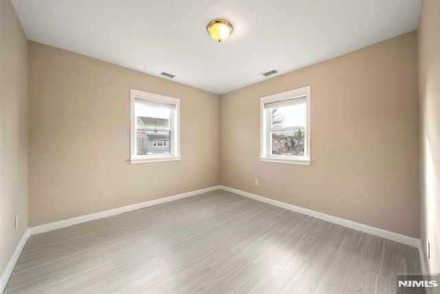 unfurnished room with wood-type flooring