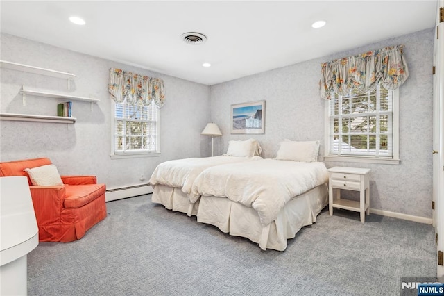 bedroom with carpet and a baseboard heating unit