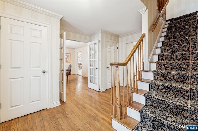 stairway featuring ornamental molding and hardwood / wood-style floors