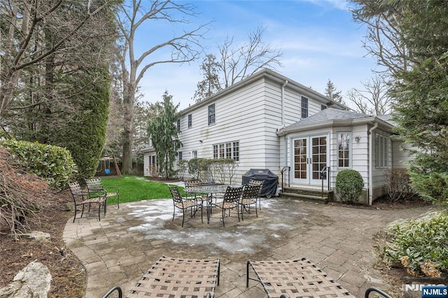 rear view of house with a yard and a patio area