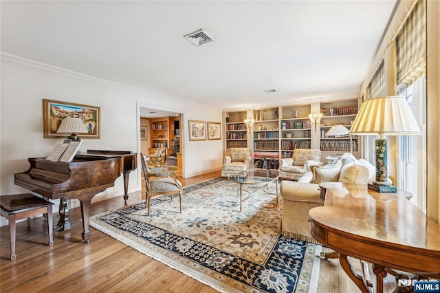 living area featuring crown molding and hardwood / wood-style floors