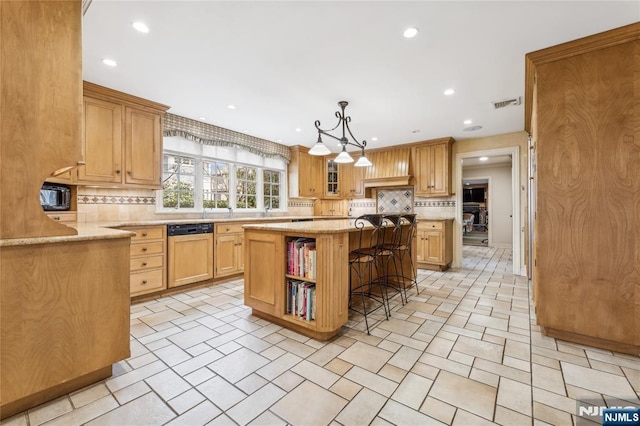 kitchen with dishwasher, a kitchen breakfast bar, decorative backsplash, a center island, and light stone counters