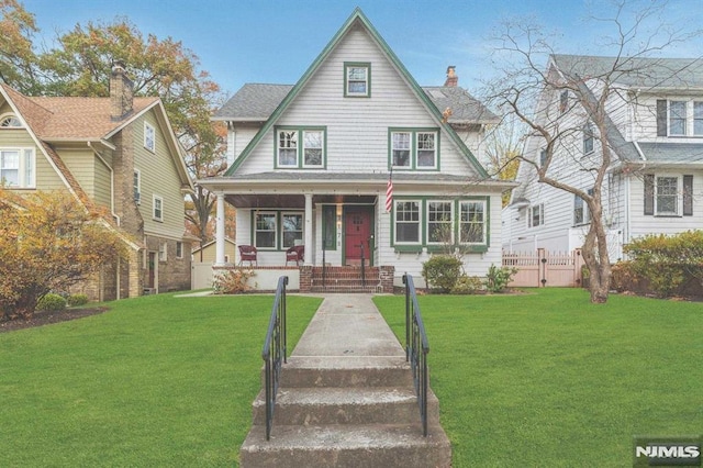 view of front facade with covered porch and a front lawn