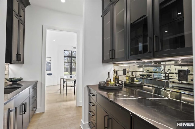 kitchen featuring decorative backsplash and light hardwood / wood-style floors