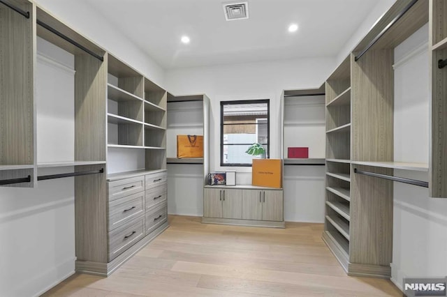 walk in closet featuring light hardwood / wood-style flooring