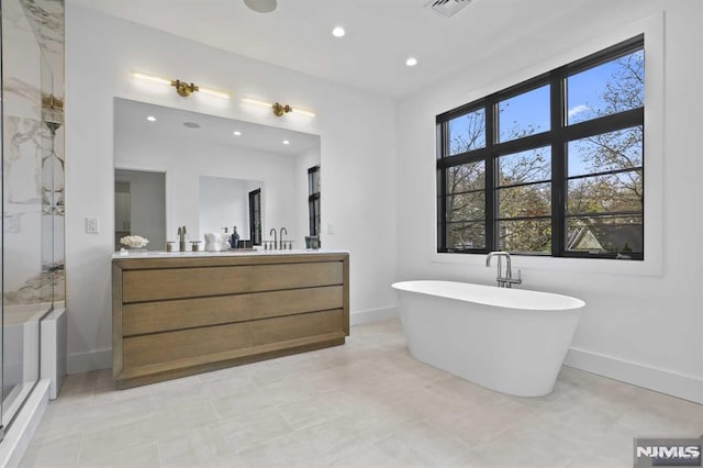 bathroom featuring vanity and a tub