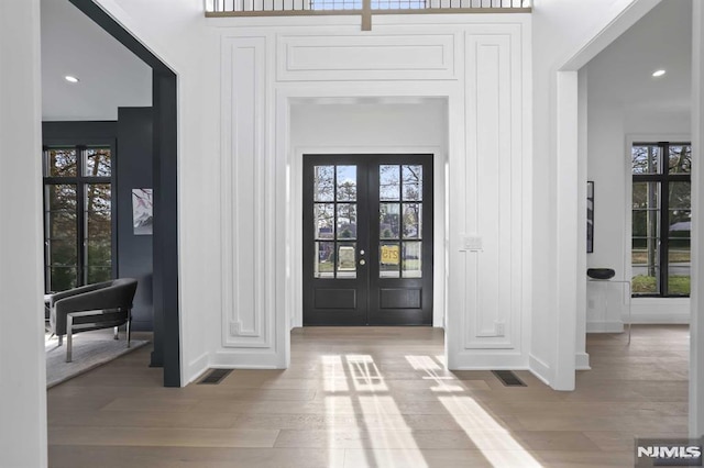 entrance foyer featuring french doors and hardwood / wood-style flooring