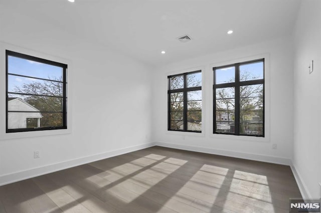 spare room featuring dark hardwood / wood-style floors