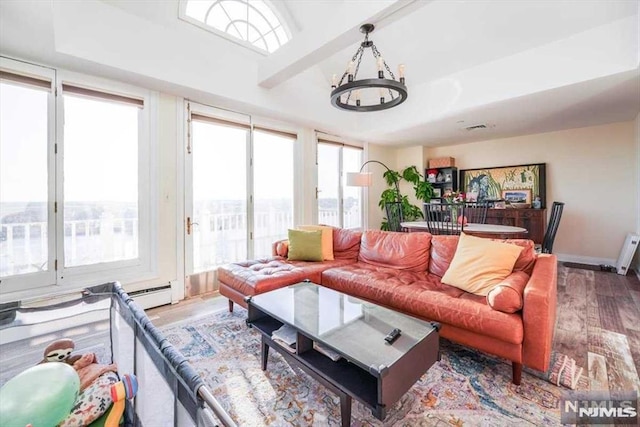 living room featuring hardwood / wood-style flooring and an inviting chandelier