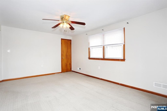 carpeted empty room with ceiling fan