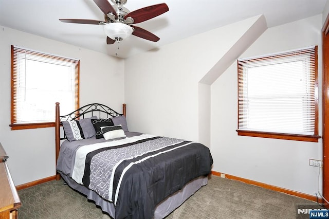 bedroom featuring dark colored carpet and ceiling fan