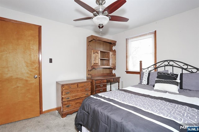 bedroom with ceiling fan and light colored carpet