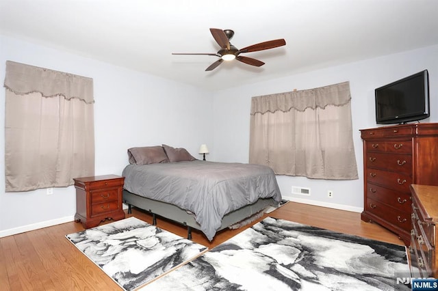 bedroom with ceiling fan and dark hardwood / wood-style flooring