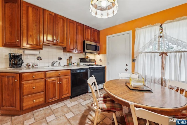 kitchen featuring black dishwasher, light countertops, stainless steel microwave, a sink, and white gas range oven