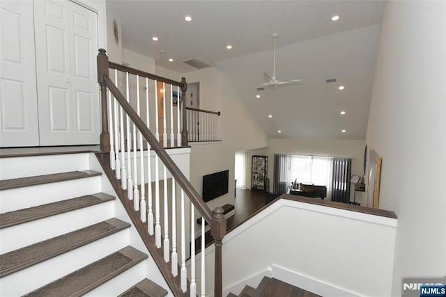 staircase with a towering ceiling, ceiling fan, visible vents, and recessed lighting