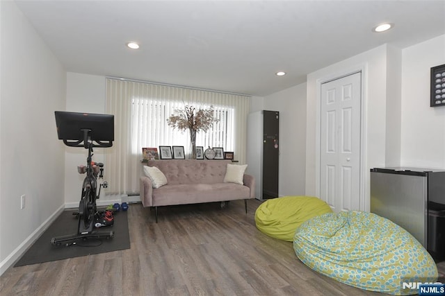 interior space with baseboards, baseboard heating, wood finished floors, and recessed lighting