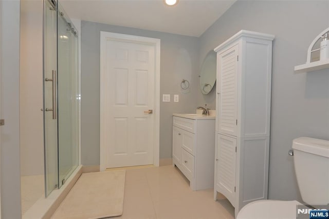 full bath featuring tile patterned floors, a shower stall, toilet, and vanity