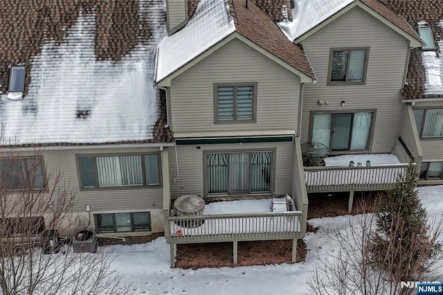 view of snow covered rear of property