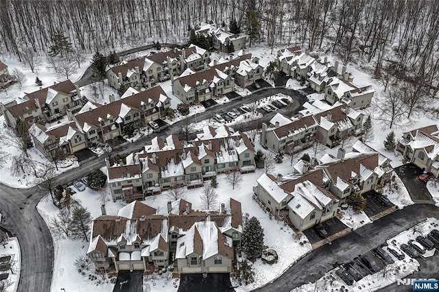 snowy aerial view featuring a residential view