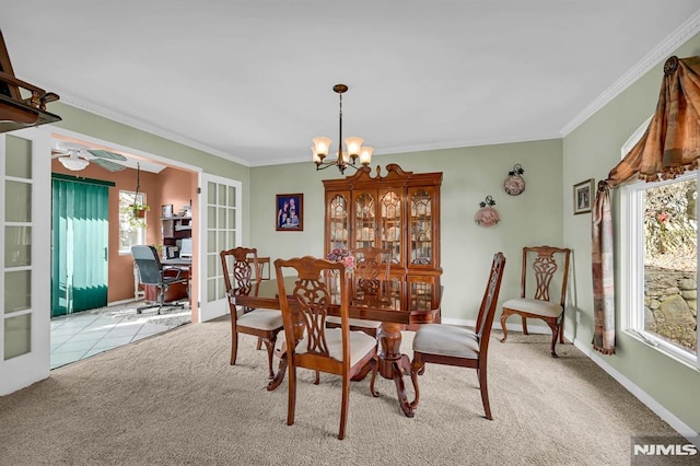 dining room with light carpet, french doors, ceiling fan with notable chandelier, and ornamental molding