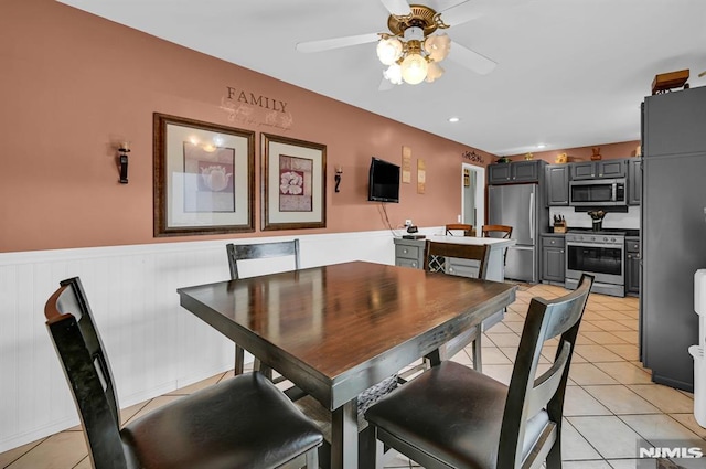 dining space with ceiling fan and light tile patterned flooring