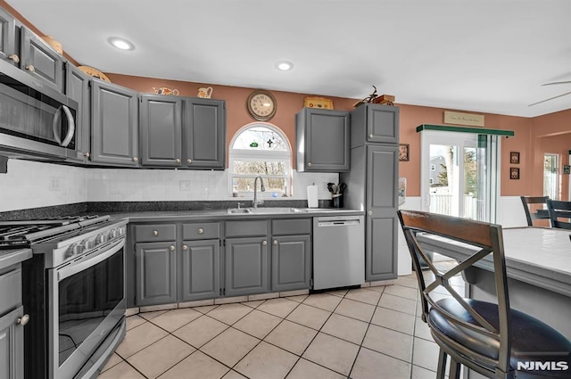 kitchen with gray cabinetry, plenty of natural light, sink, and stainless steel appliances