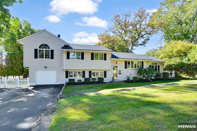 tri-level home with a front yard and a garage