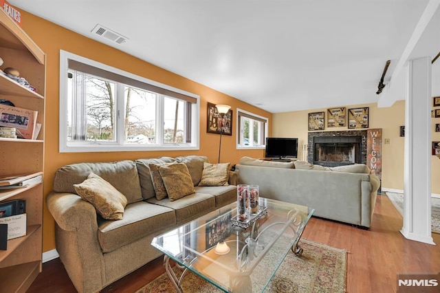 living room with hardwood / wood-style floors and rail lighting