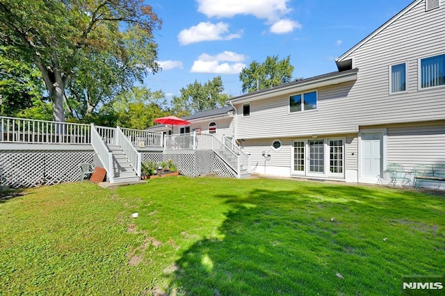 exterior space with a deck and a lawn