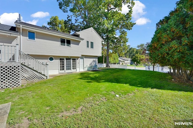 rear view of property featuring a yard