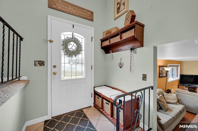 foyer entrance with light tile patterned floors