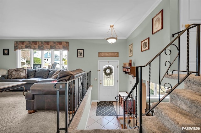 tiled foyer entrance featuring crown molding