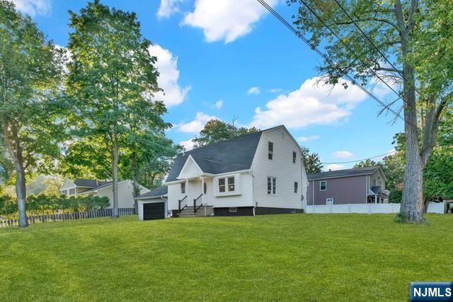 rear view of property featuring a yard