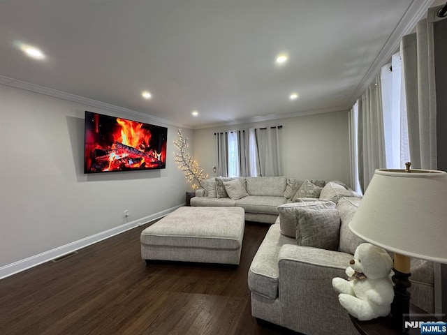 living room with dark hardwood / wood-style flooring and crown molding