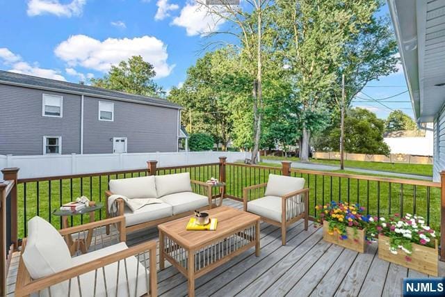 wooden terrace with a yard and an outdoor hangout area