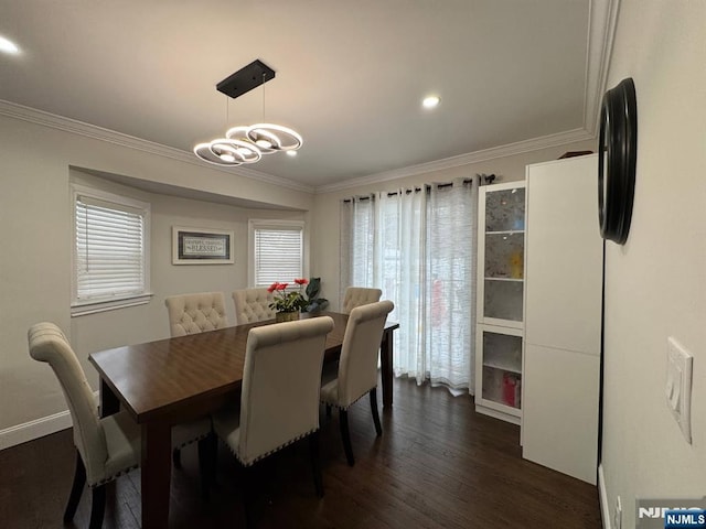 dining space featuring ornamental molding, a chandelier, and dark hardwood / wood-style flooring