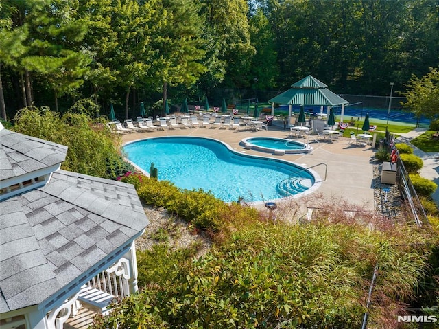 view of swimming pool featuring a gazebo, a patio area, and a community hot tub