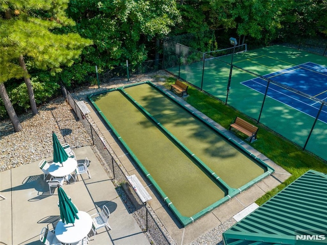 view of property's community featuring tennis court