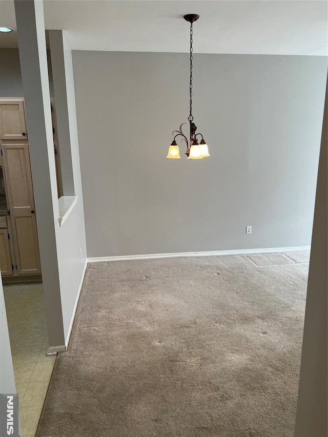 unfurnished dining area with light carpet and a notable chandelier