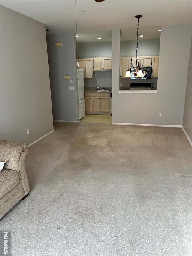 unfurnished living room with sink and light carpet