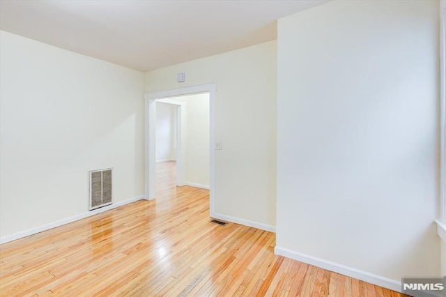 spare room featuring light hardwood / wood-style floors