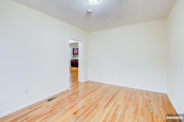 unfurnished room with light hardwood / wood-style floors