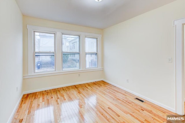 spare room with light wood-type flooring