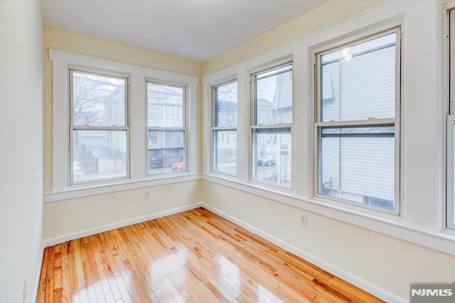 unfurnished sunroom featuring plenty of natural light