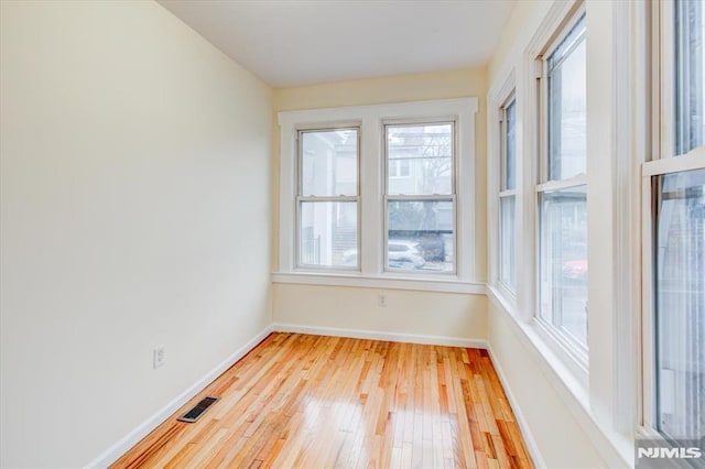 unfurnished room with light hardwood / wood-style flooring