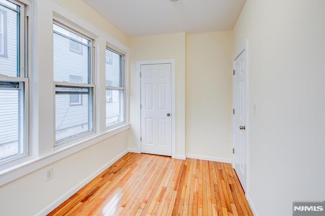 unfurnished room with light hardwood / wood-style floors