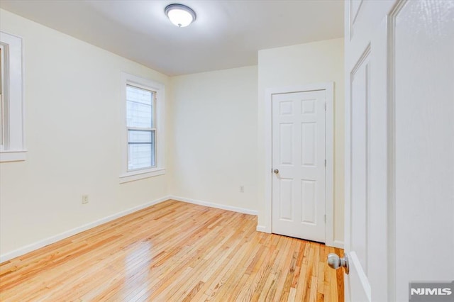 unfurnished room with light hardwood / wood-style floors