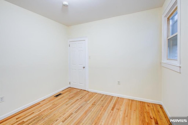 spare room with hardwood / wood-style floors