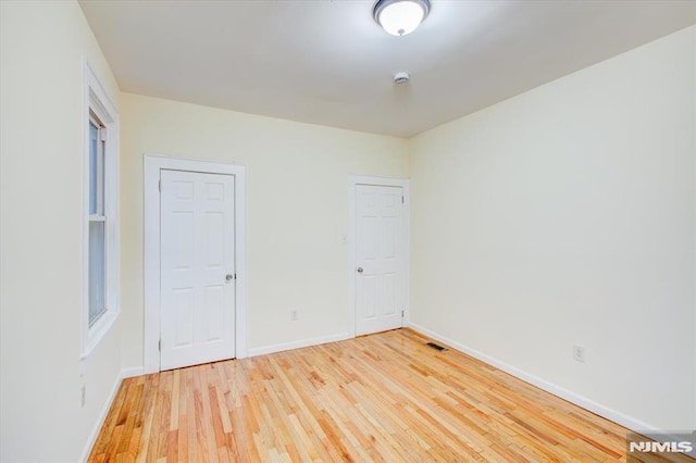 empty room with hardwood / wood-style floors